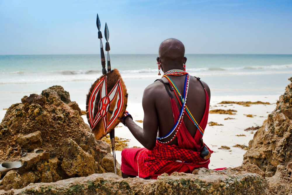 Maasai Man sitting by the Beach, in Traditional Attire