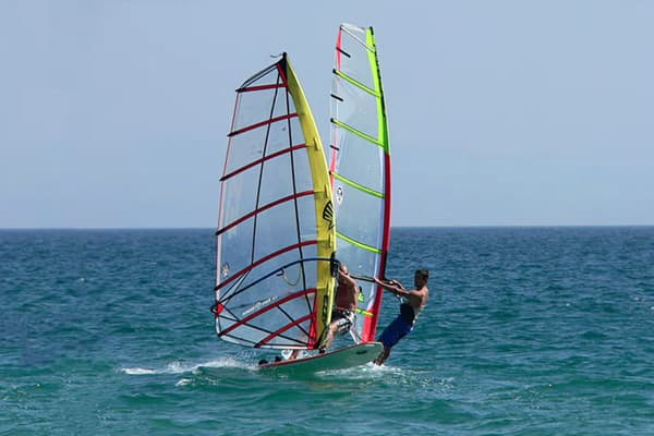 Men wind surfing